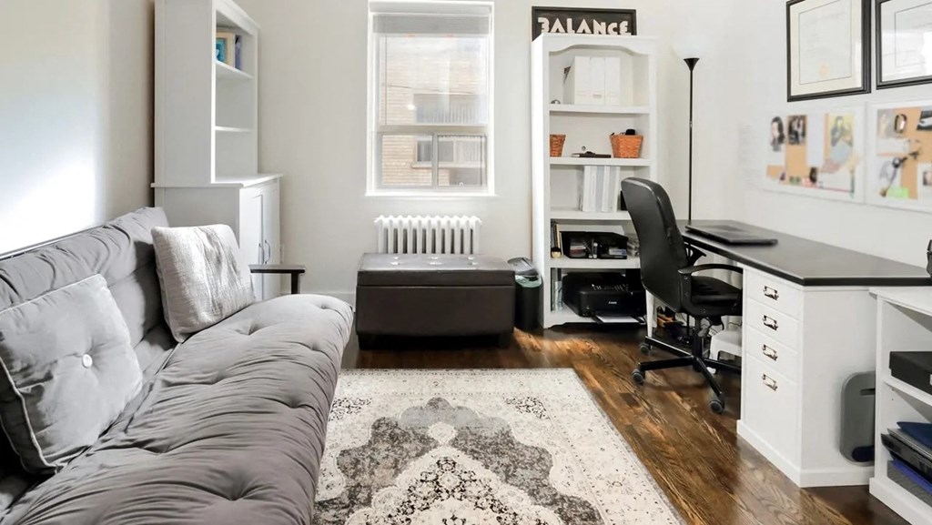 a living room with a couch and a desk