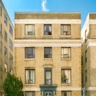 a large brick building with windows in a city