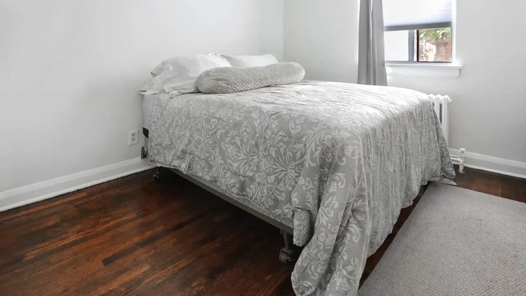 a bedroom with a bed and a window