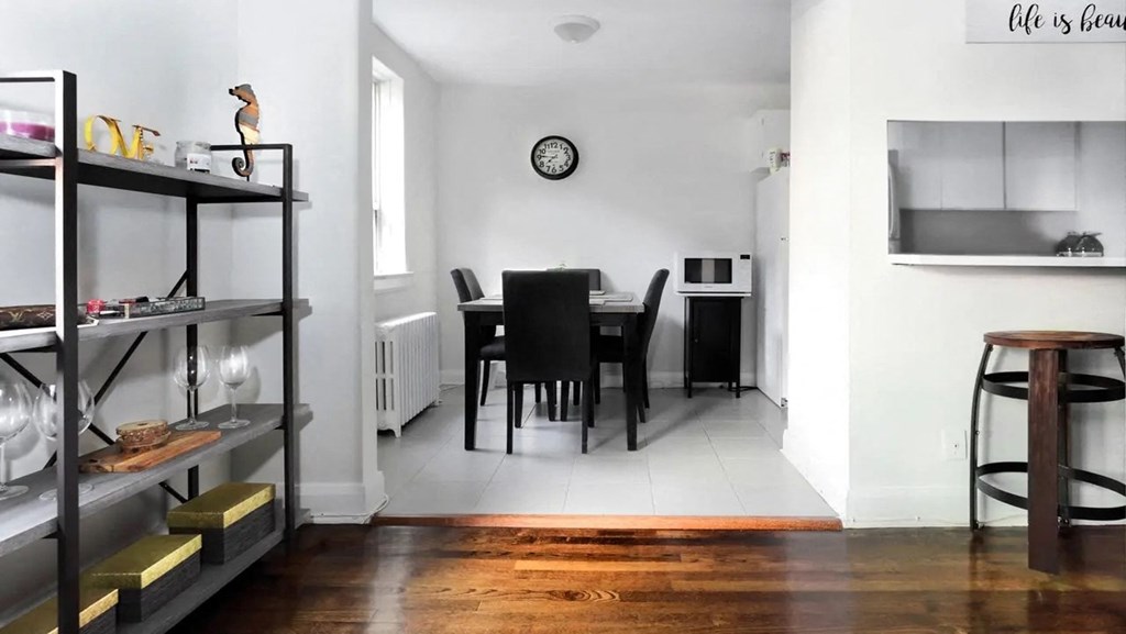a living room and dining room with a table and chairs