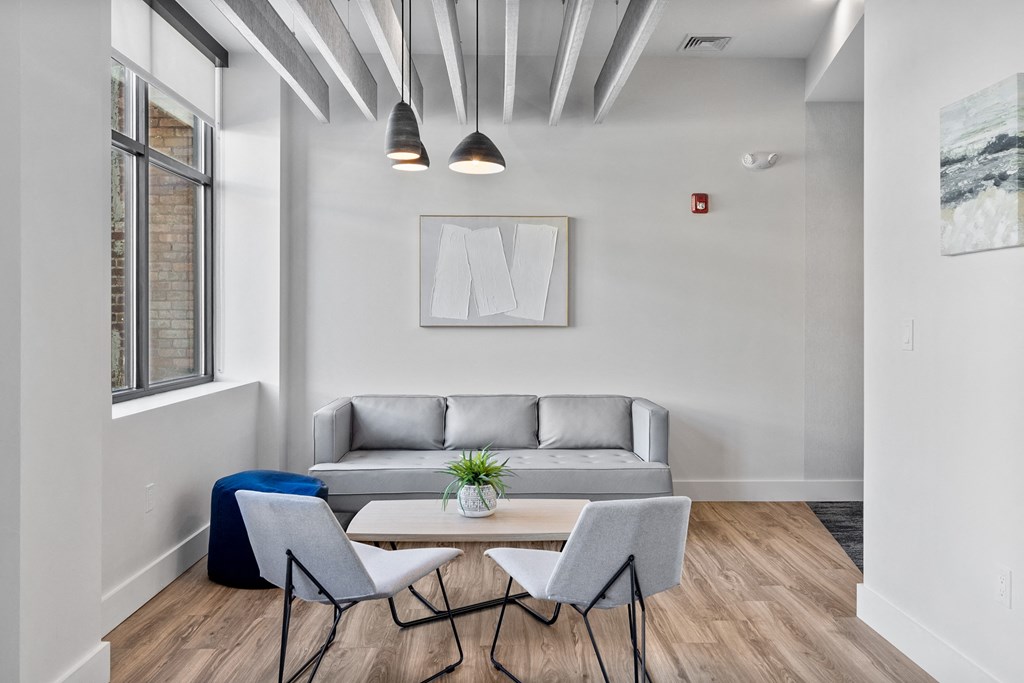 a living room with a couch and a table and chairs