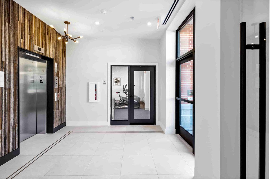 the lobby of a condo with a door to the living room