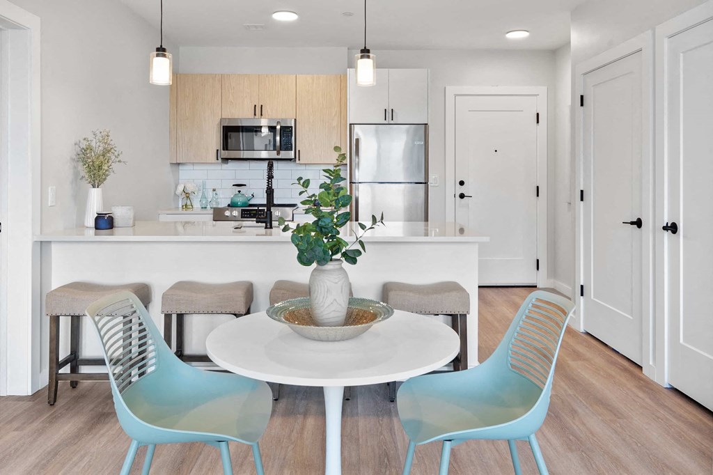 an open kitchen and dining room with a table and chairs