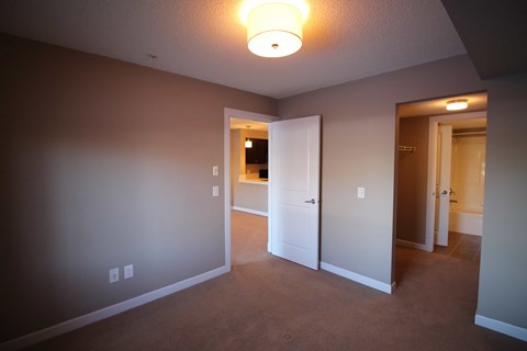 a bedroom with a closet and a door to a bathroom