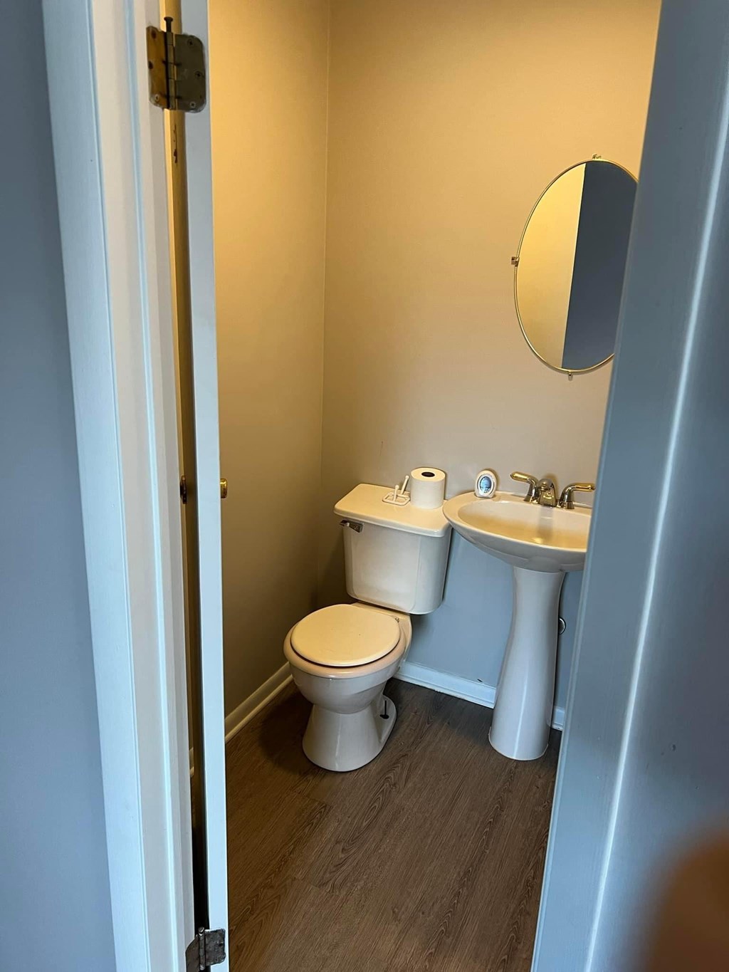 a bathroom with a toilet sink and a mirror