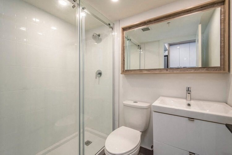 a bathroom with a toilet and a sink and a shower