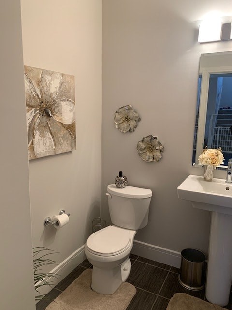 a bathroom with a toilet and a sink and a mirror