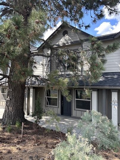 A house with a tree in front of it.