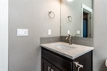 A bathroom with a sink and mirror.
