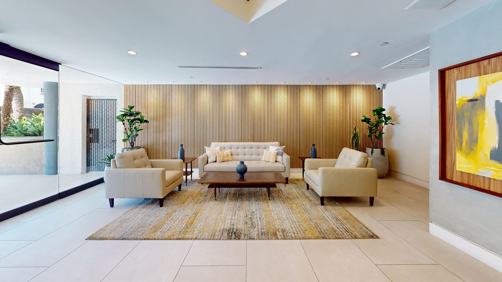 a living room with couches and chairs and a rug