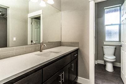 a bathroom with a sink and a toilet and a mirror