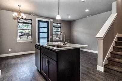an empty kitchen with a sink and a staircase
