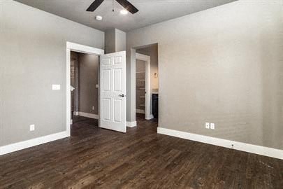 a empty living room with wooden floors and a white door
