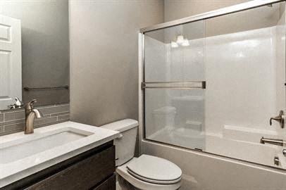 a bathroom with a toilet and a sink and a shower