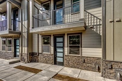 the front entrance of a building with a patio and a door