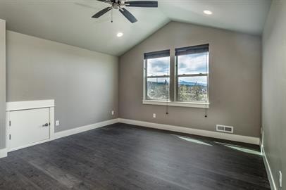 A room with a ceiling fan and a large window.