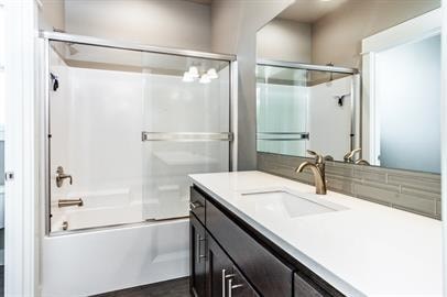 A white sink is in a black and white bathroom.