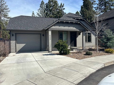 A house with a grey roof and a grey garage door.
