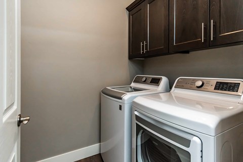 Two front loading washing machines in a laundry room.