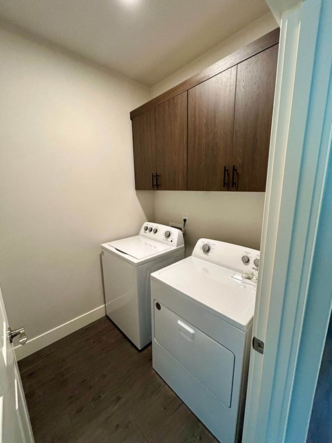 A small laundry room with a washer and dryer.