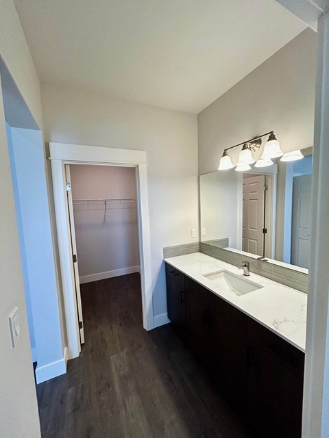 A bathroom with a sink and mirror.