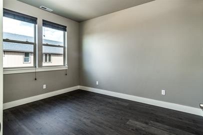 A room with a window and a grey wall.