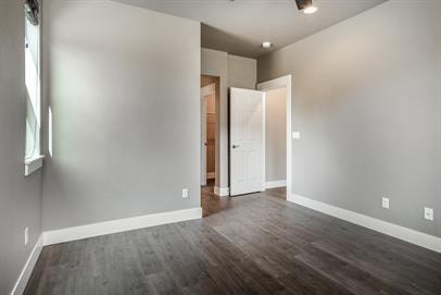 A room with a wooden floor and a white door.