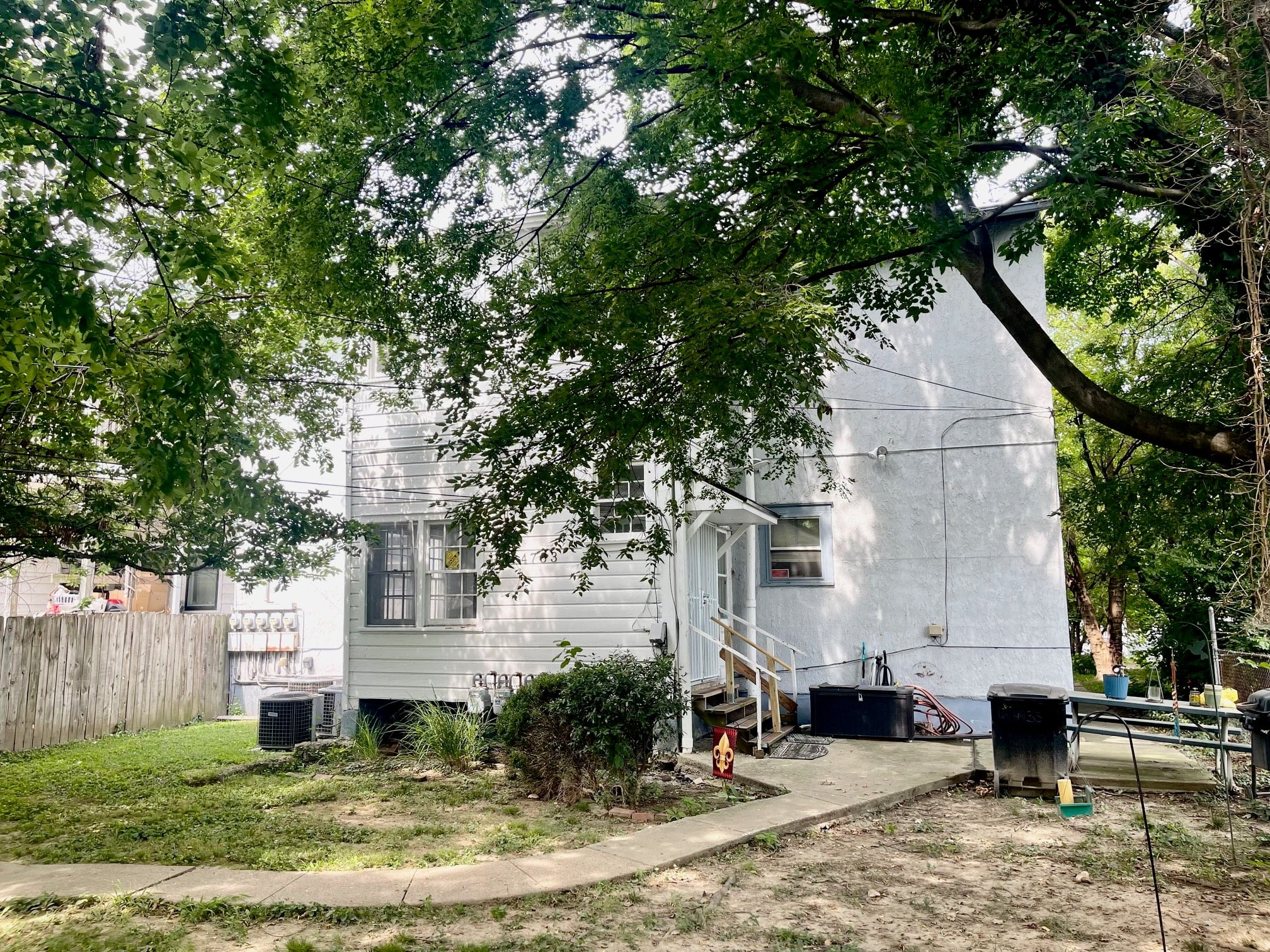 a white house with a yard and trees