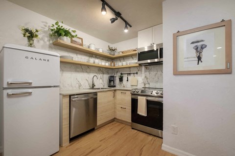 a kitchen with a refrigerator and a stove