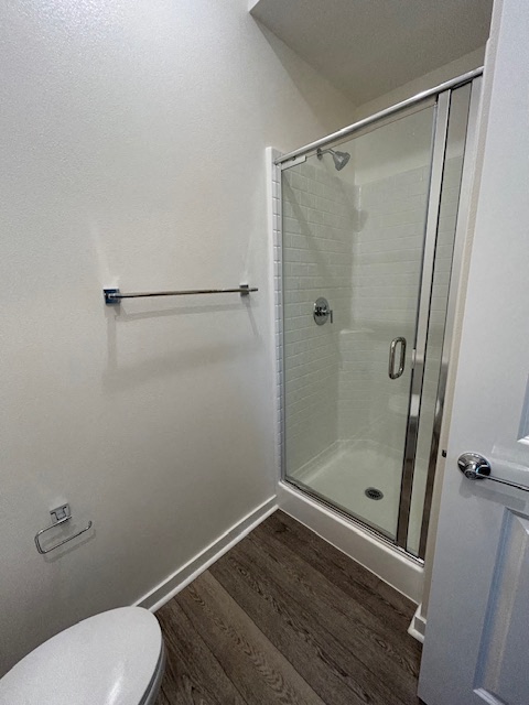 a small bathroom with a shower and a toilet