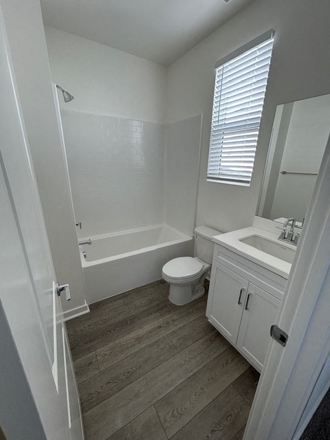 a bathroom with a toilet and a sink and a bath tub