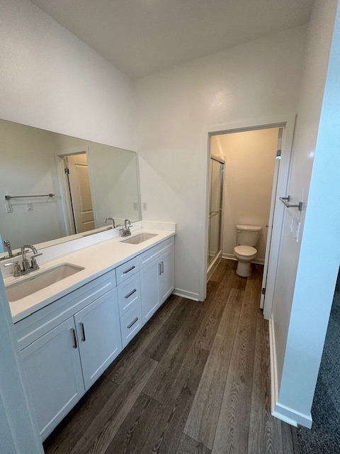 a bathroom with two sinks and a toilet