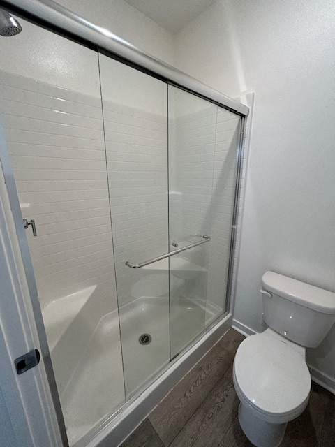 a bathroom with a toilet and a shower