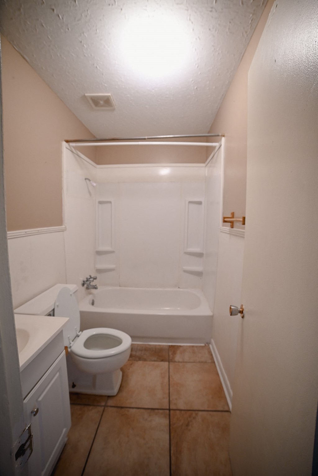 a bathroom with a toilet and a tub and a sink