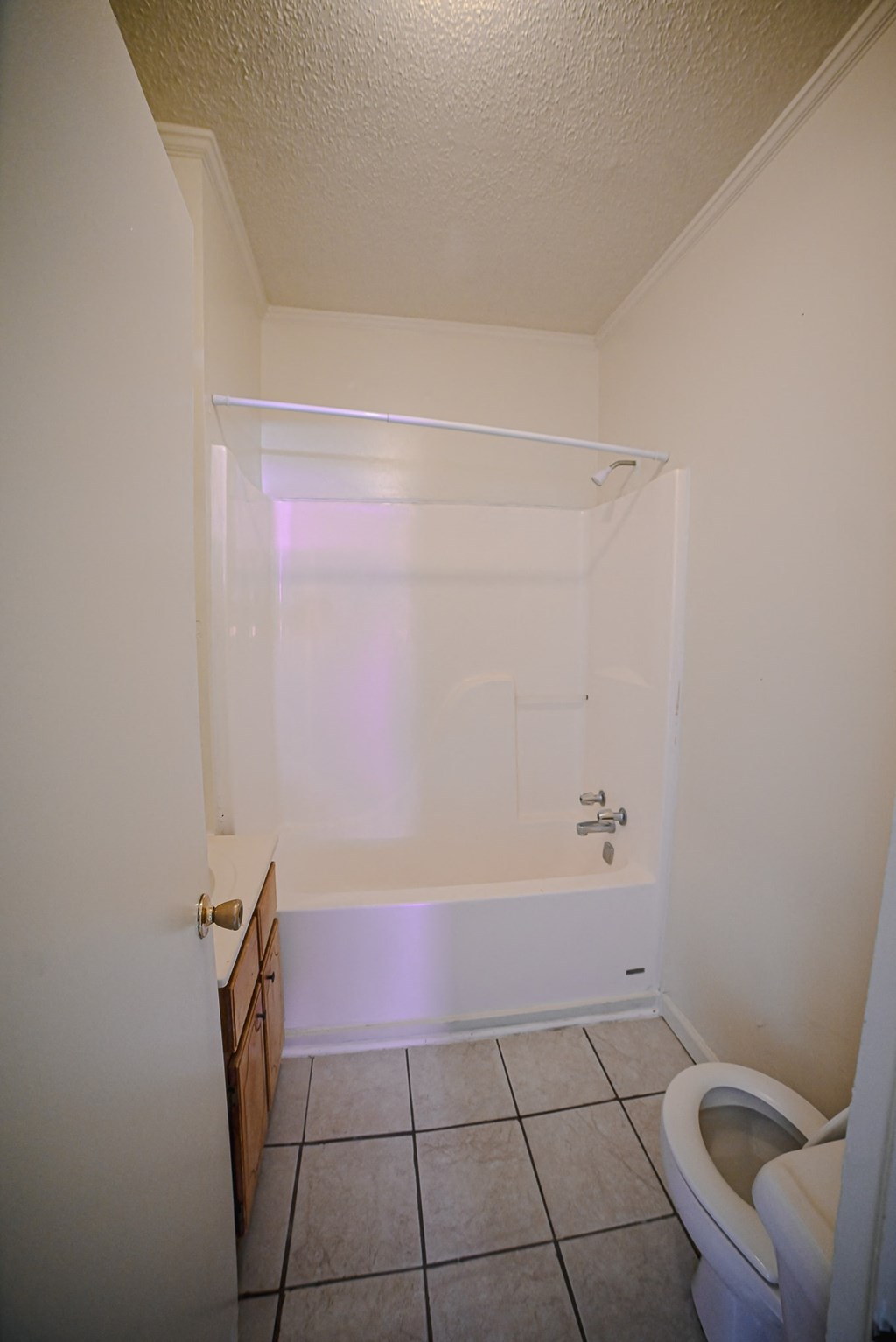 an empty bathroom with a toilet and a tub