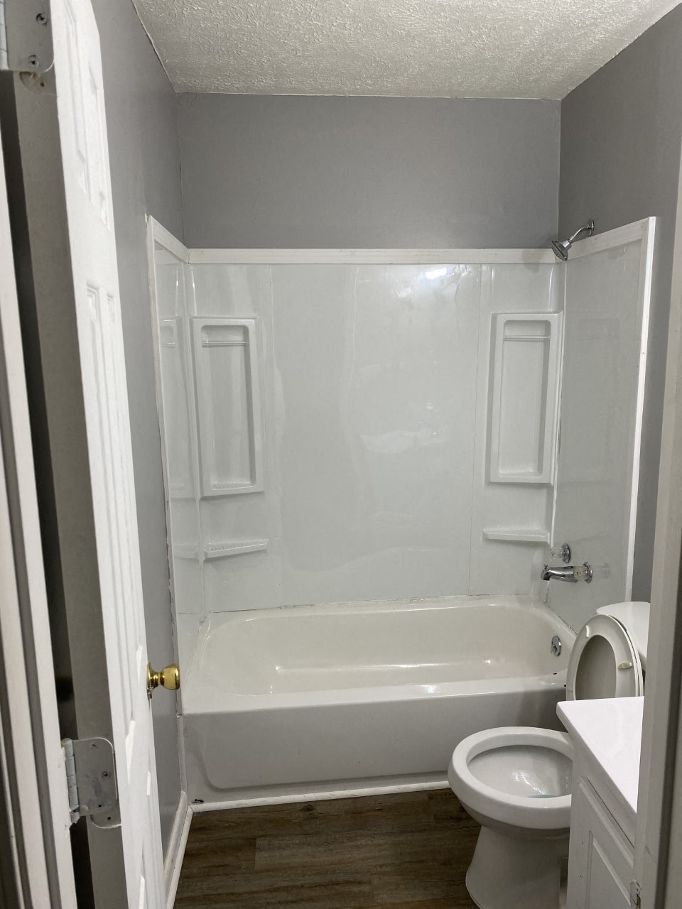 a bathroom with a toilet and a tub and a sink
