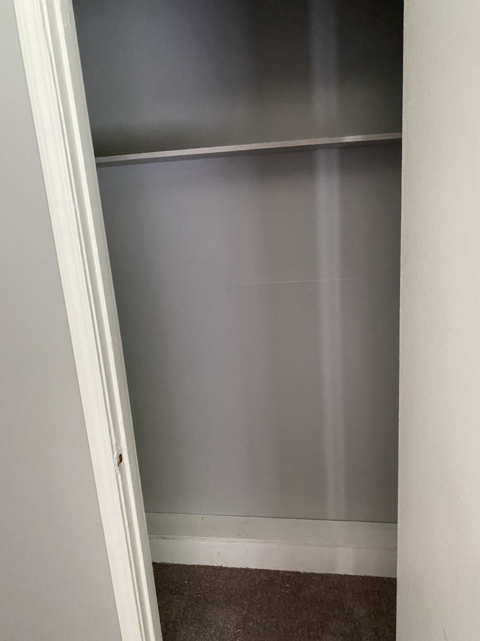 the bottom of a closet with the door open