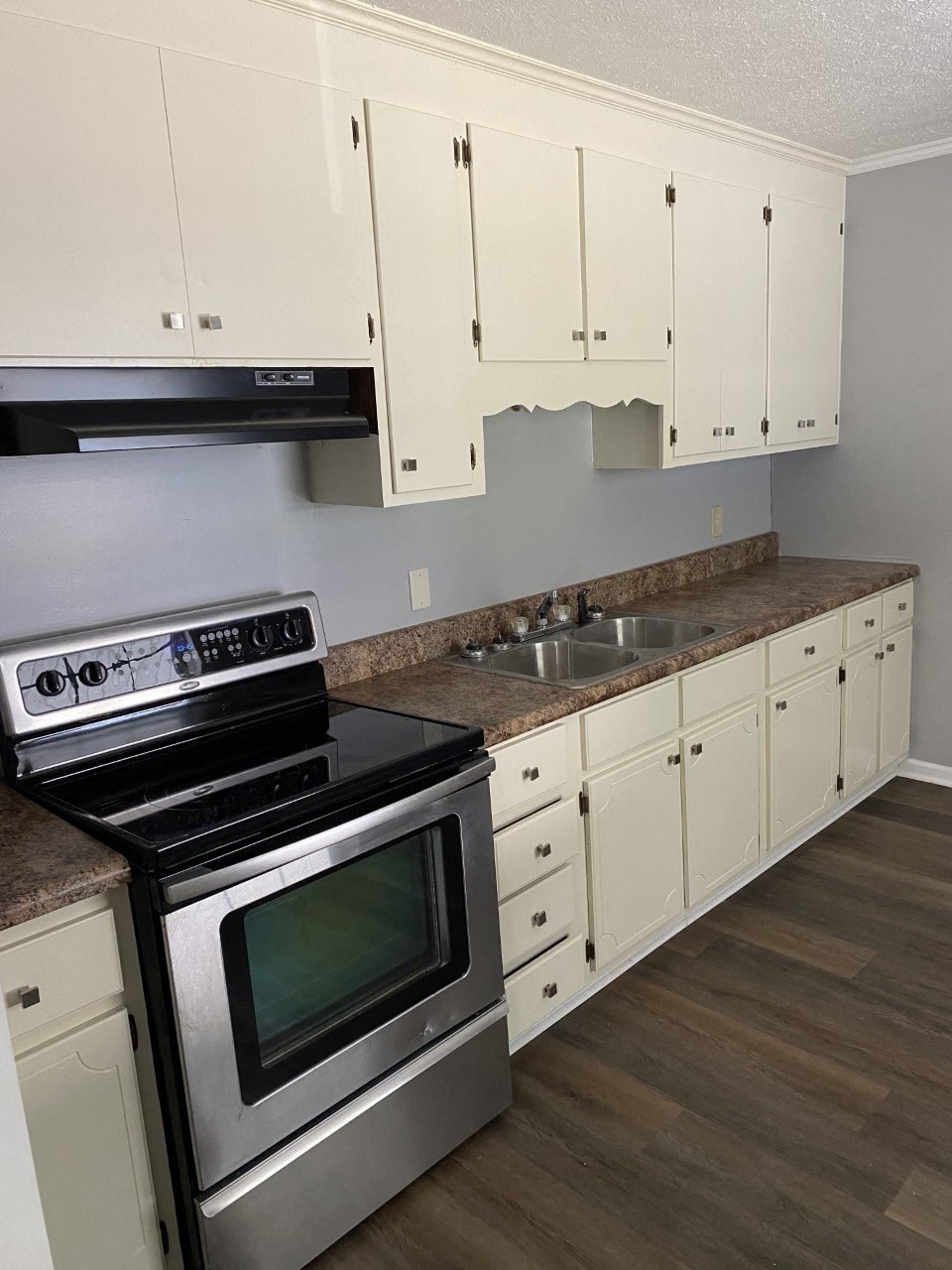 a kitchen with stainless steel appliances and white cabinets