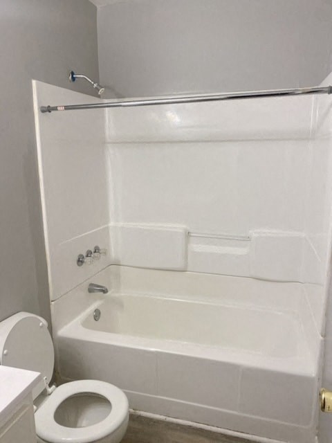 a white bathroom with a toilet and a bath tub