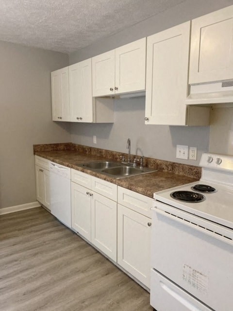 a kitchen with white appliances and white cabinets