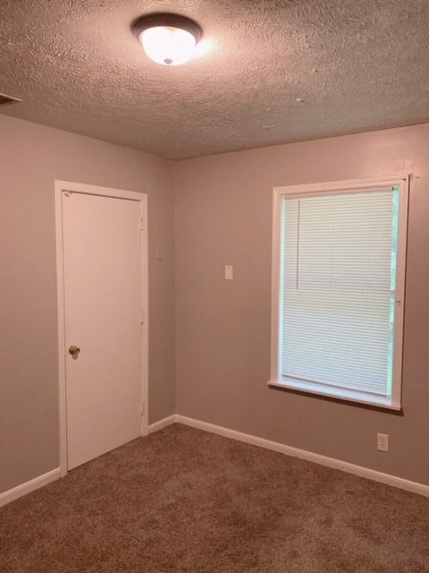 an empty room with a window and a door