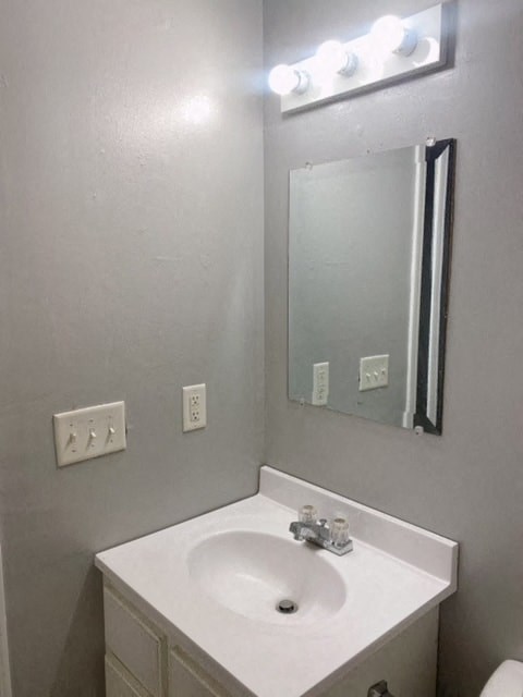 a bathroom with a white sink and a mirror