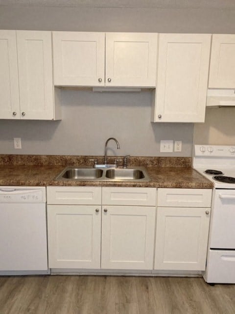 a kitchen with white cabinets and a sink