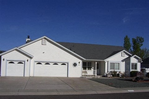 a white house with a driveway and a garage door