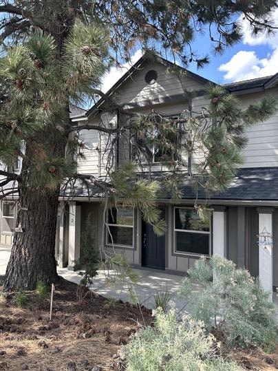 A house with a tree in front of it.