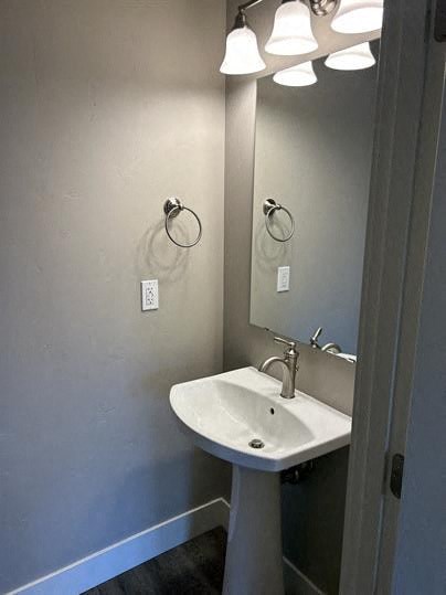 A bathroom with a sink and a mirror.