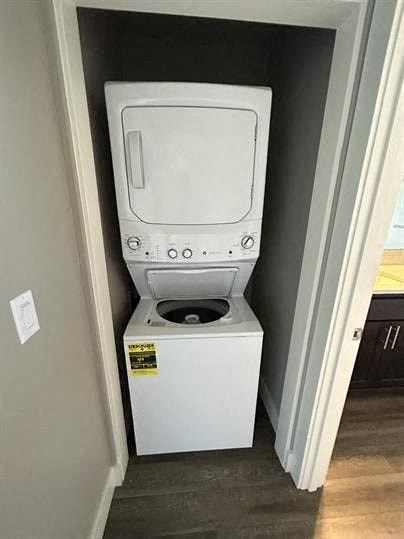 A white toilet with a sticker on the side is in a small room.
