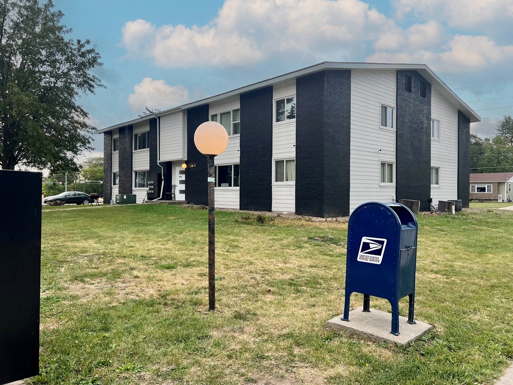 a building with a mailbox and a balloon in front of it