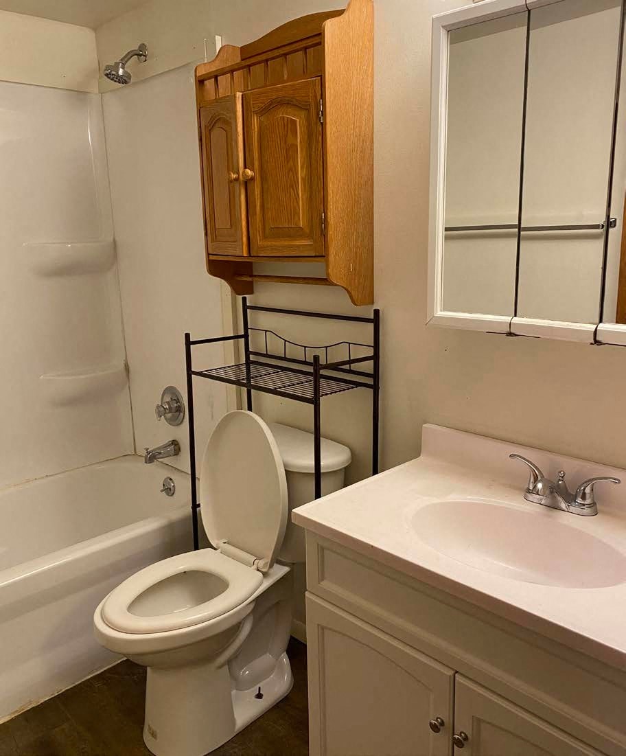 a bathroom with a toilet and a sink and a bath tub