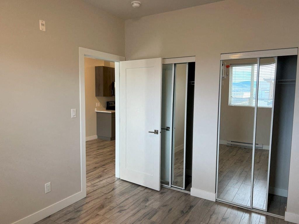 an empty room with a mirror and a closet